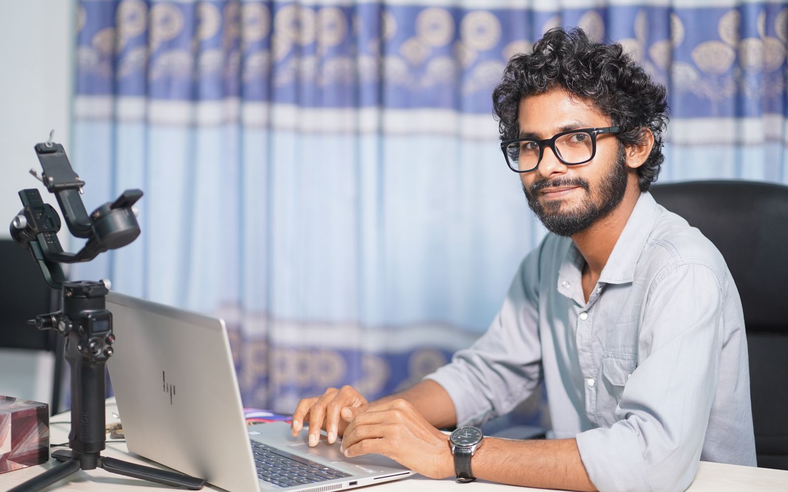 Portrait of a web developer working on a laptop, showcasing technical and professional skills.