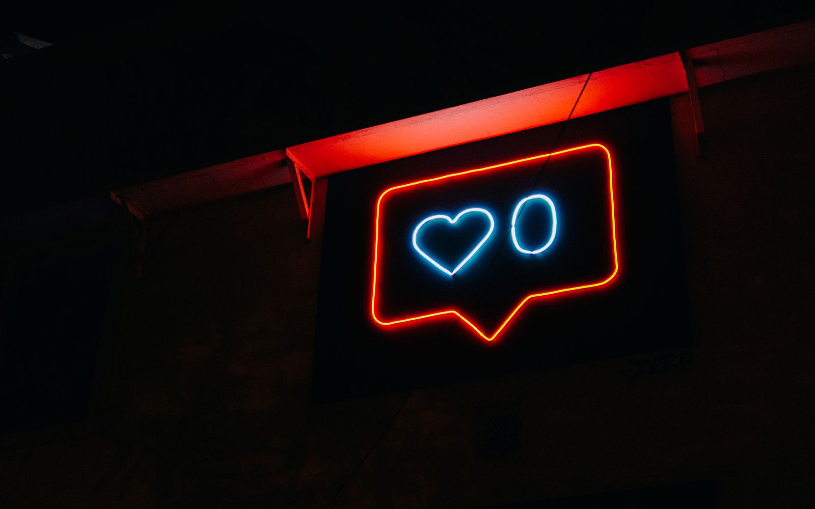 Bright neon heart icon with zero likes, symbolizing social media engagement.