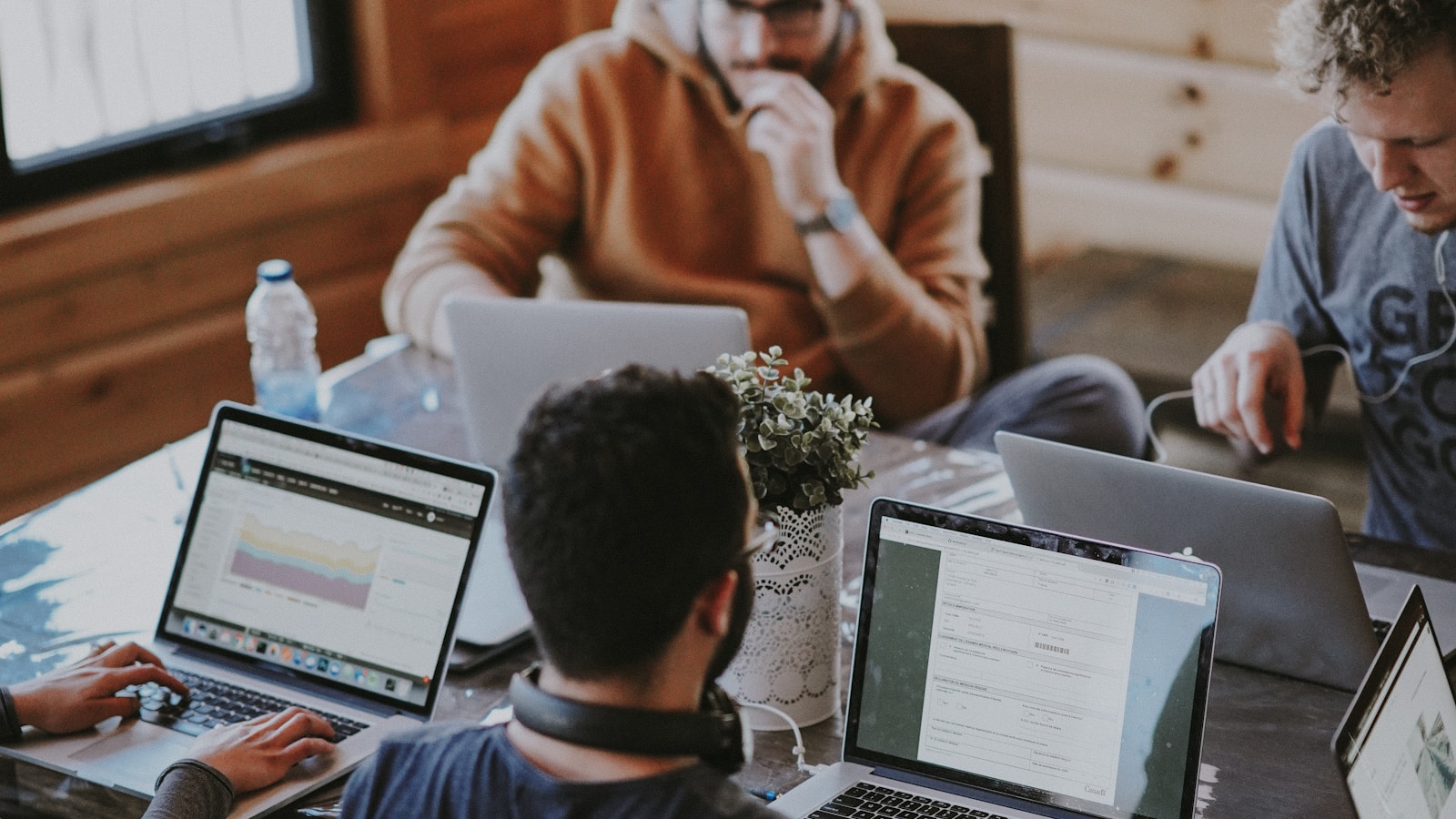 Developers collaborating around laptops during a controlled publishing workflow.