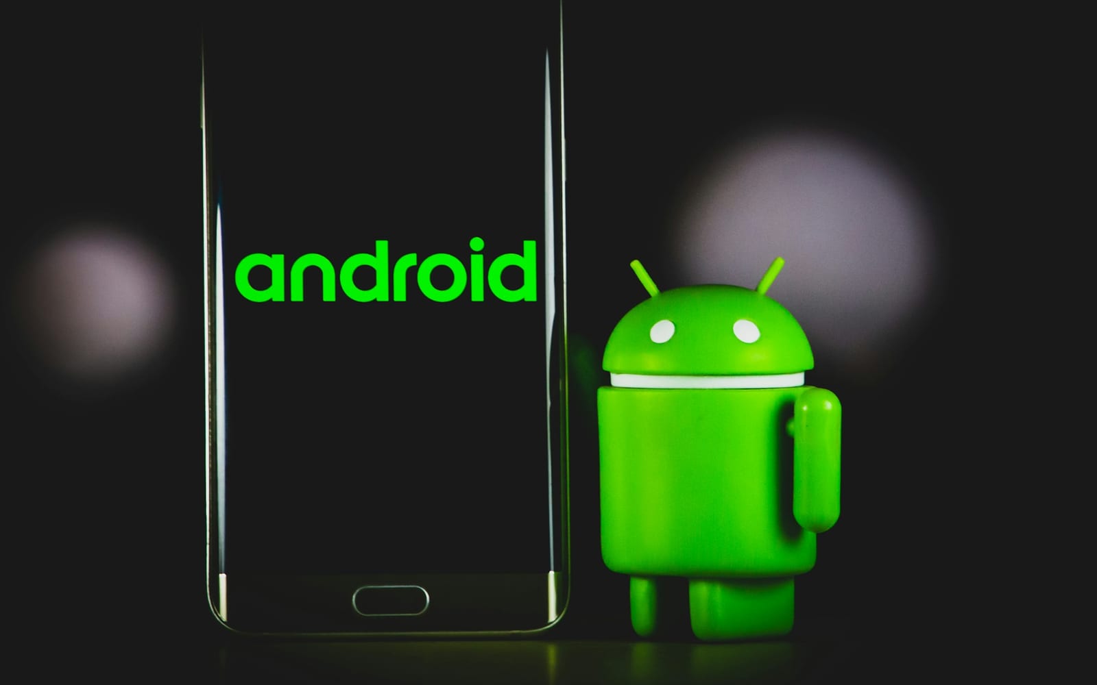 green frog iphone case beside black samsung android smartphone