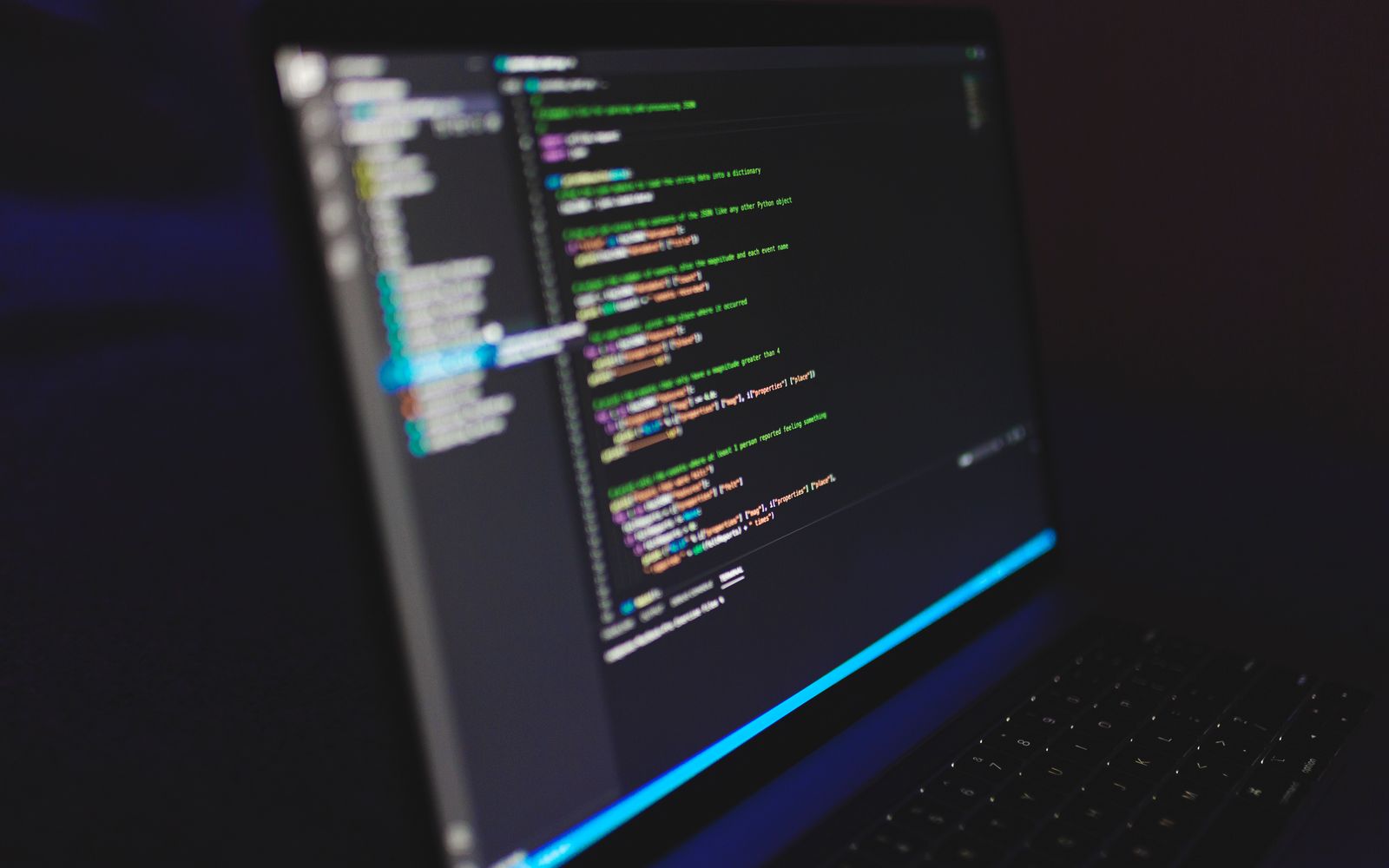 Laptop displaying code in a dark setting, highlighting programming concepts and digital work.