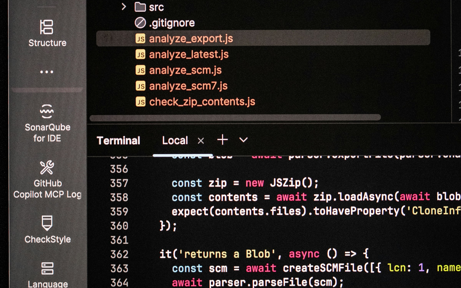 Computer monitor showing source code and terminal output