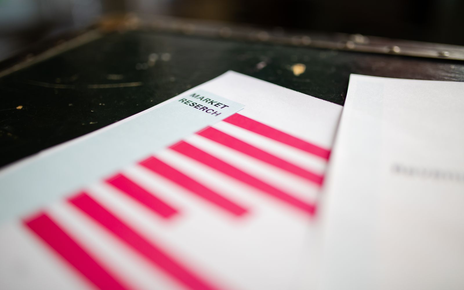 A detailed close-up of a market research document featuring a bar graph and a focus on market trends.