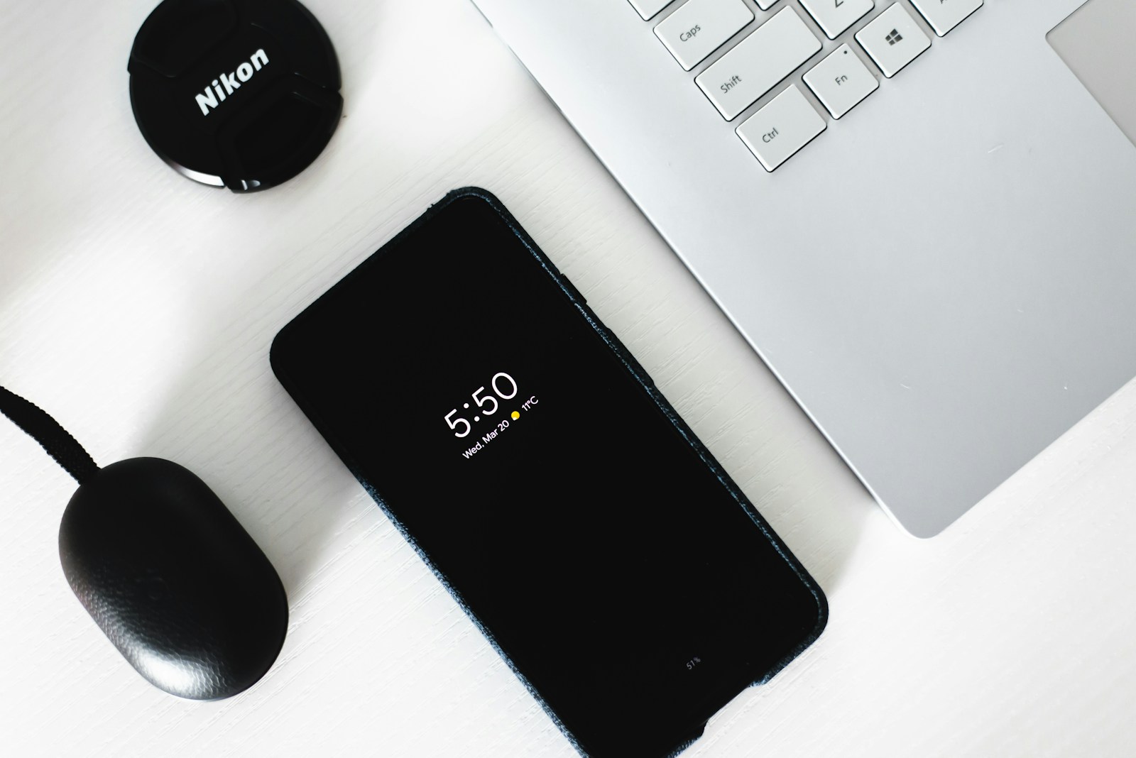 An Android phone beside a laptop representing mobile data and device testing.