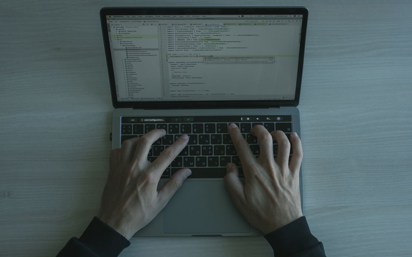 Close-up view of a programmer coding on a laptop, showcasing modern software development.