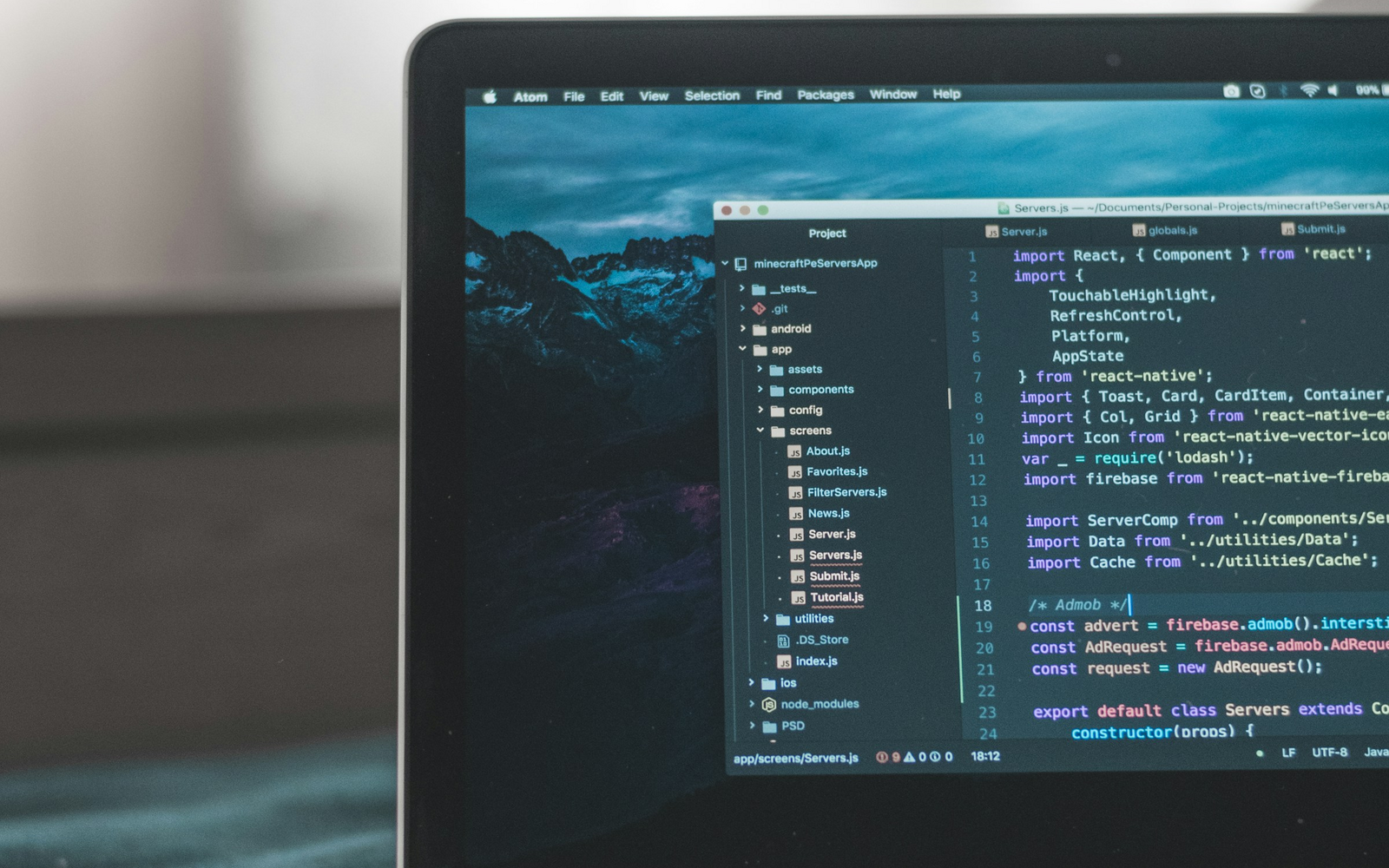 Laptop displaying source code on a developer workspace